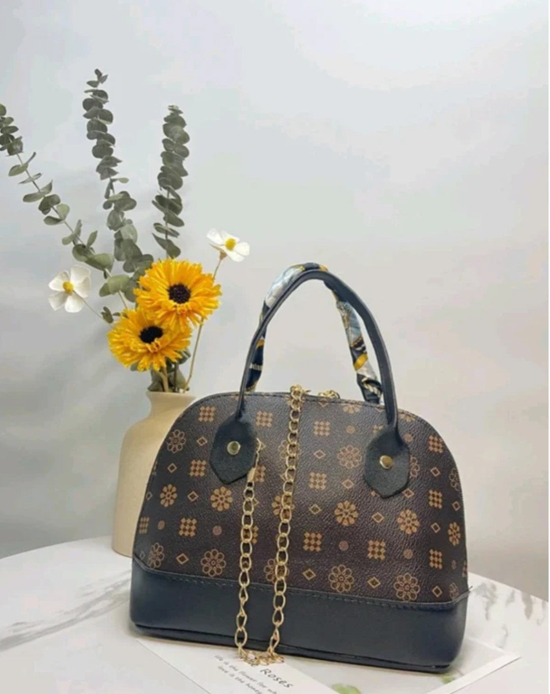 Designer handbag with floral pattern and sunflower decoration 