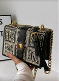 Black and gold patterned handbag with chain strap 