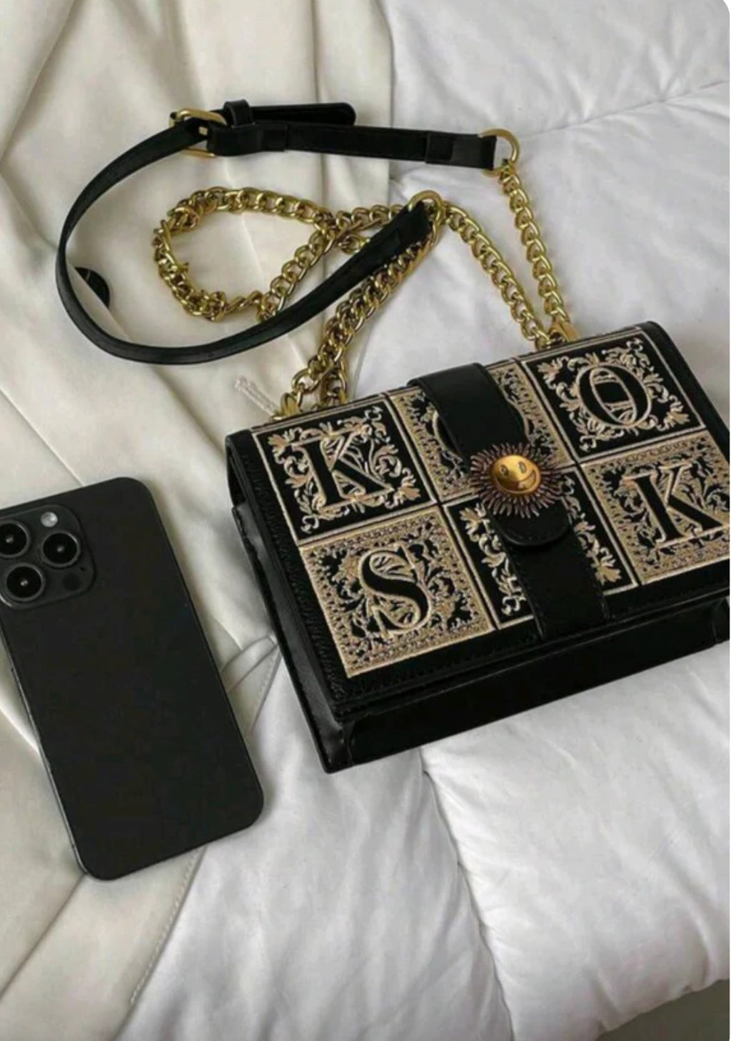Black handbag with gold accents 