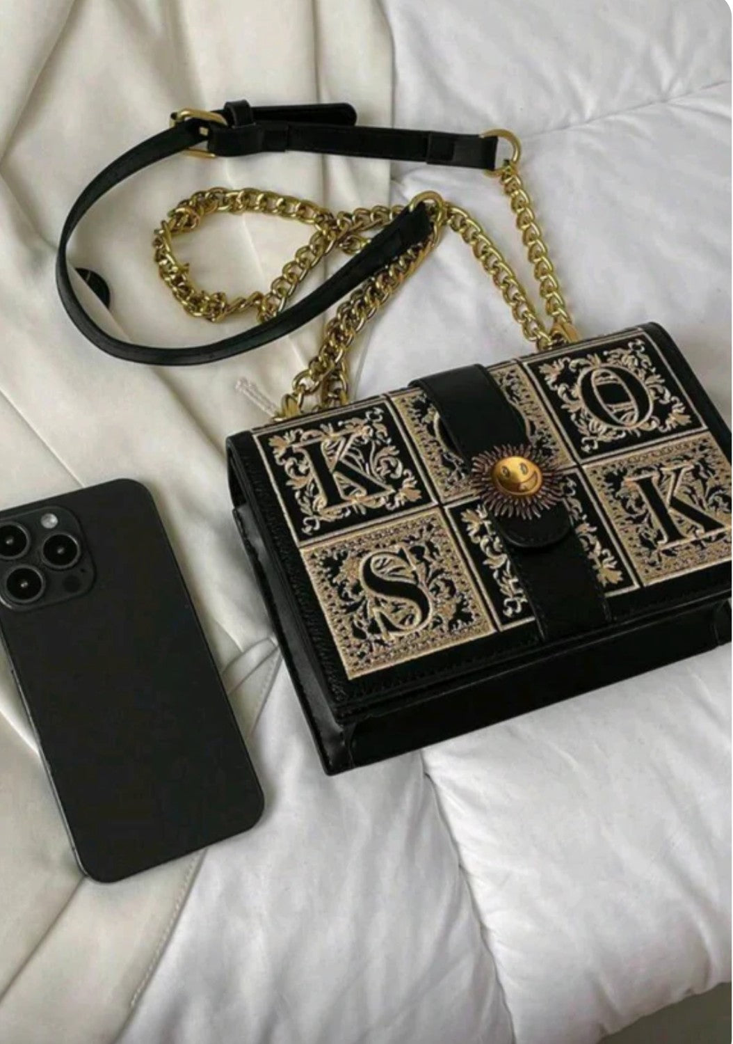 Black handbag with gold accents 