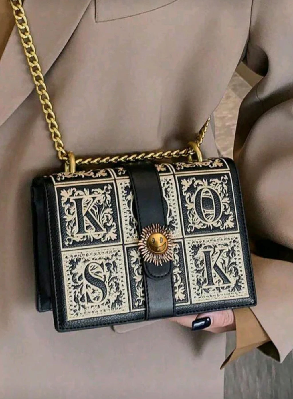 Designer handbag with decorative pattern and gold chain strap 